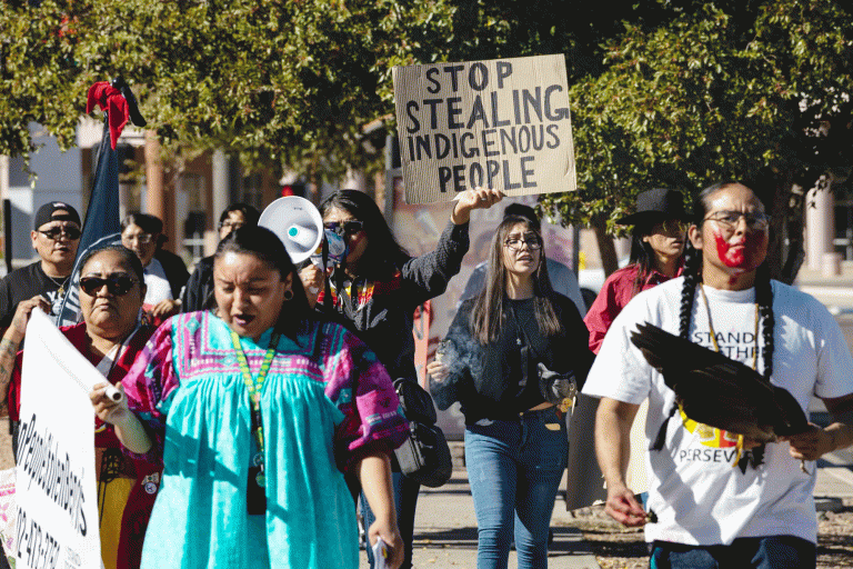 A group of volunteers with Turtle Island Women Warriors demonstrate outside the Arizona Capitol in November 2024 to raise awareness about Indigenous community members displaced by the state's massive Medicaid fraud scheme.
