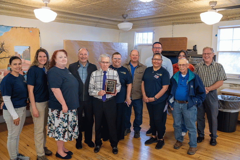 Winslow Rotary Club members pose with Citizen of the Year Lloyd Engelhardt (center) during last week’s Good Morning Winslow meeting. Pictured are (left to right) Amber Martinez, Lona King, Jessica Cox-Atha, Greg Hackler, Engelhardt, Leane Bowley, Lawrence Kenna, Kristy Armijo, Travis Udall, Jeff Hartman, Danie Therio and Harold Soehner.