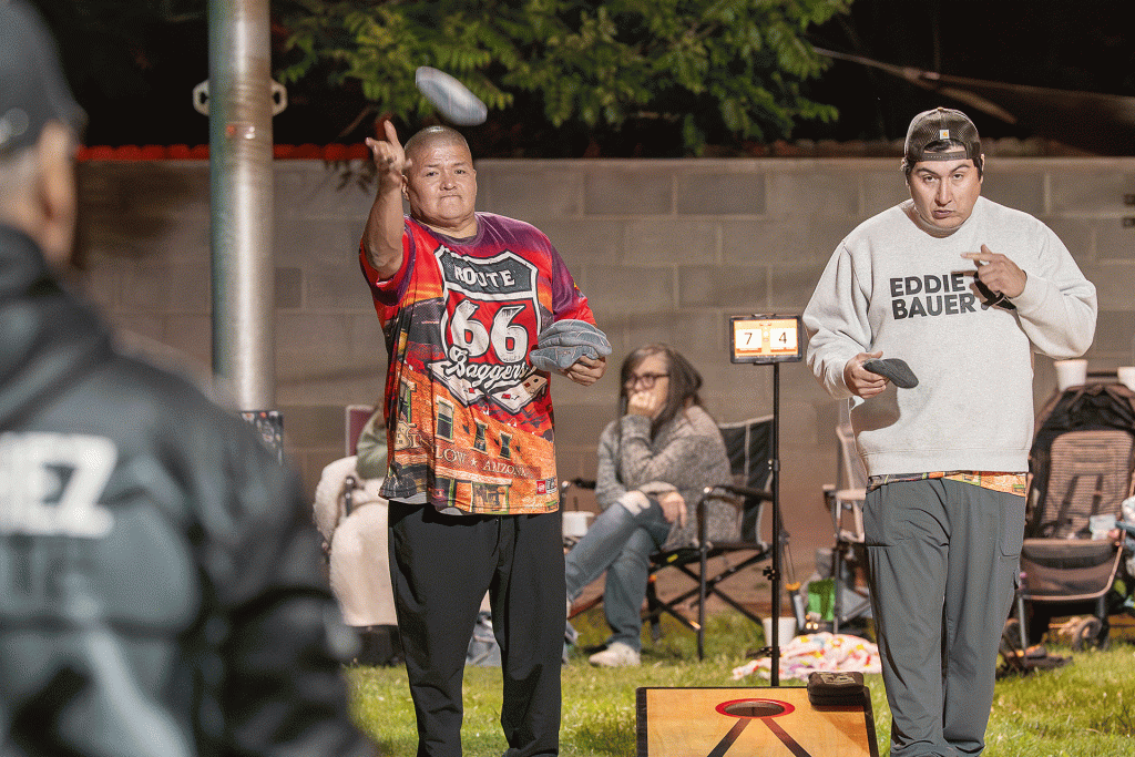 Terry Katoney (left) tosses a bean bag Saturday during a cornhole tournament at Standin’ on the Corner Park in Winslow, while opponent Paul Mazon (right) waits his turn. The event was one of the first city-sponsored events tied to Winslow’s Route 66 centennial celebration and was also sponsored by the Route 66 Baggers, a local cornhole group that meets twice a month for tournaments.
