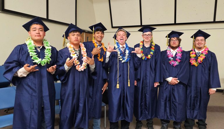 Classmates (left to right) Tatum Dixon, Jaimen Tsosie, Eli James, Cort Miller, Luke Miller, Leon Howerton and Wyatt Bowler stand together one last time as classmates before graduation.