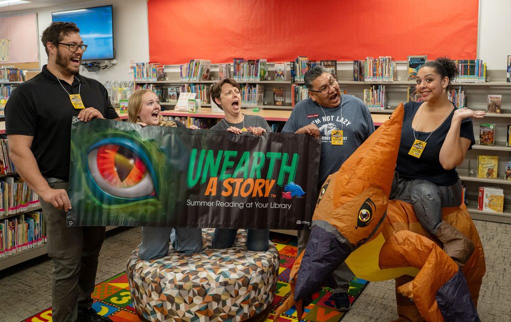 Dinosaurs may be extinct, but the Winslow Library’s summer reading program is bringing them back to life with “Unearth a Story,” a free dinosaur-themed initiative encouraging readers of all ages to explore books throughout the summer. Staff members (left to right) Joshua Friedan, Kennedy Arend, Brandee Leary, Michael Luther and Danie Therio are helping promote the program, which includes prizes such as Arizona Diamondbacks tickets, pool passes and Bearizona admission, while adults 21 and older can also enter to win giveaways including a two-night stay at Desert Diamond Casino and many more prizes! Community members interested in participating can contact the library for information on how to sign up.