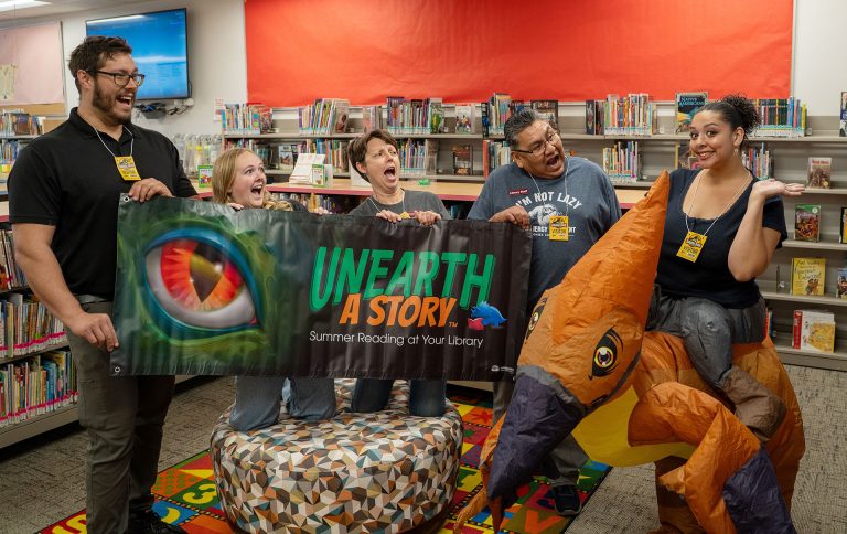 Dinosaurs may be extinct, but the Winslow Library’s summer reading program is bringing them back to life with “Unearth a Story,” a free dinosaur-themed initiative encouraging readers of all ages to explore books throughout the summer. Staff members (left to right) Joshua Friedan, Kennedy Arend, Brandee Leary, Michael Luther and Danie Therio are helping promote the program, which includes prizes such as Arizona Diamondbacks tickets, pool passes and Bearizona admission, while adults 21 and older can also enter to win giveaways including a two-night stay at Desert Diamond Casino and many more prizes! Community members interested in participating can contact the library for information on how to sign up.