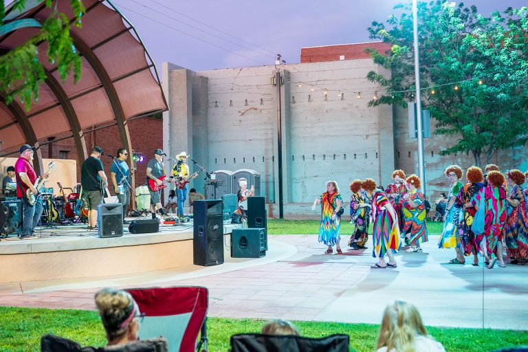 Local cover band Perfect Storm performed Saturday at Route 66 Plaza as participants in the first Roper Romp on Route 66 danced during the first June Jams concert of the summer. The Roper Romp, organized by Mayor Birdie Cano, saw participants dressed in clothes inspired by Helen Roper from the television show “Three’s Company.”