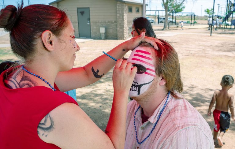 Cheri Sahmie, a member of the Winslow Arts Council paints the face of Jayden Bay at the Winslow community picnic hosted by the Winslow Chamber of Commerce.