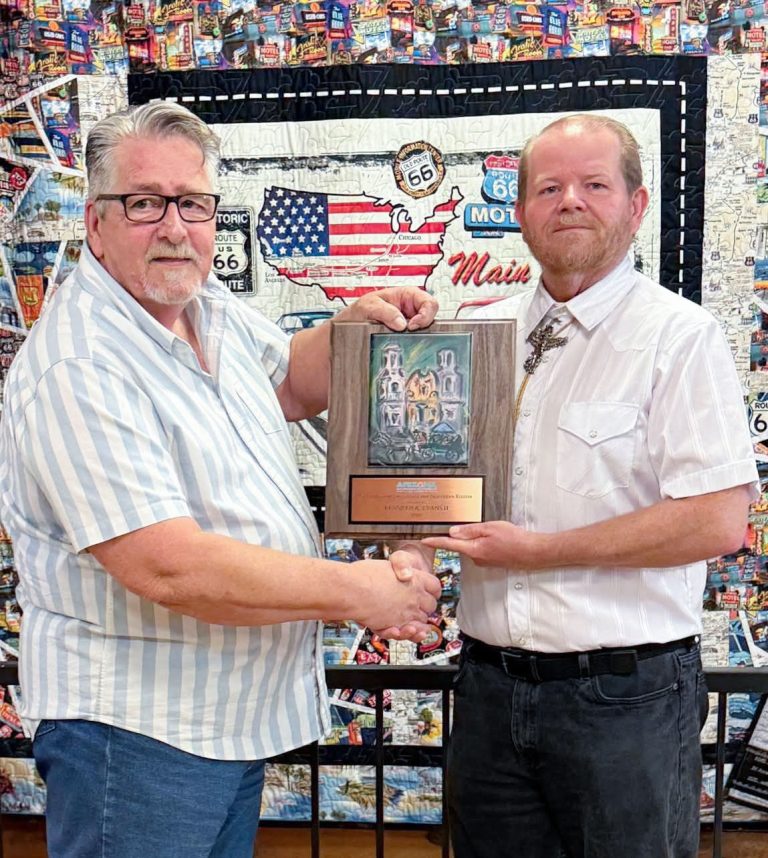 Winslow resident Kenn Evans II (right) was presented with the Stewardship Excellence Northern Region 2026 award at the Arizona Governor’s Conference on Tourism. Also pictured is Winslow Chamber of Commerce CEO Bob Hall (left).