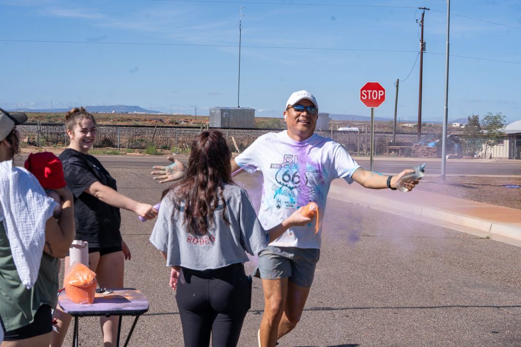 Photo by Shawn White Volunteers douse Navajo County Supervisor Alberto Peshlakai in powdered color as he makes his way through the Color Run 5K in Winslow last Saturday. The run was hosted by Winslow Indian Health Care Center and the Winslow Chamber of Commerce as part of the community’s Route 66 Centennial celebration.