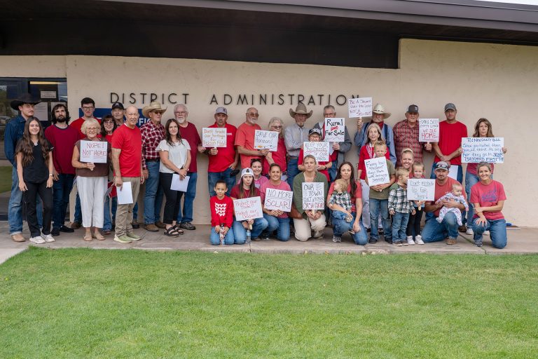 Residents opposed to Invenergy's proposed Honeymoon Trail Energy Center gather outside the Joseph City school district during last week’s open house.