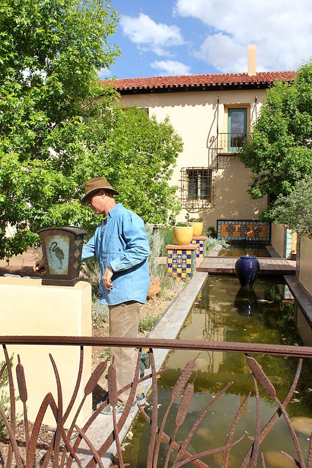Photo by Dan LutzickWinslow artist John Suttman was at work installing his handcrafted iron lanterns along the Potager Garden walls at La Posada Hotel last week. Not only does Suttman create the iron lantern fixtures, he also designs and creates the image embedded glass plates for the lamps.