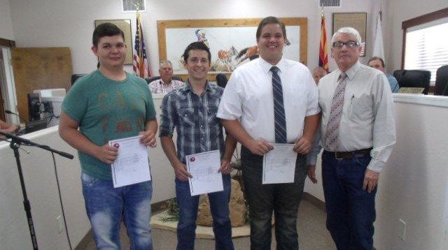 Photo by Naomi HatchMembers of the Taylor Town Council thanked Boy Scouts (left to right) Guy Lewis, Nick Larson and Dillan Owens last week for their Eagle projects, and the work they did to get the rodeo grounds ready for the Independence Day Celebration, and improve the community and parks for years to come. Dillan provided new trash receptacles to help maintain the sanitation and appearance of Freeman Park for the 50th Celebration of Incorporation and for Rodeo Park. Nick extended the water to the north side of the rodeo arena, and Guy provided more fencing and corrals for the town rodeo. Mayor Fay Hatch (right) presented them with certificates of appreciation at the July 7 council meeting.