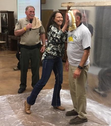 Photo courtesy of the Bread of Life Mission - Navajo County Sheriff K.C. Clark (left) and Navajo County Attorney Brad Carlyon (right) competed to raise funds for Bread of Life Mission of Holbrook. The winner was to “pie” the loser at the mission’s annual banquet held Oct. 1. Sheriff Clark won, then offered to sell his “pie” rights for $100, an offer taken up by his wife, Brenda Clark (center). Clark and Carlyon were excellent sports, offering anyone at the event the opportunity to pie either of them for $25. According to those present, they had plenty of takers.