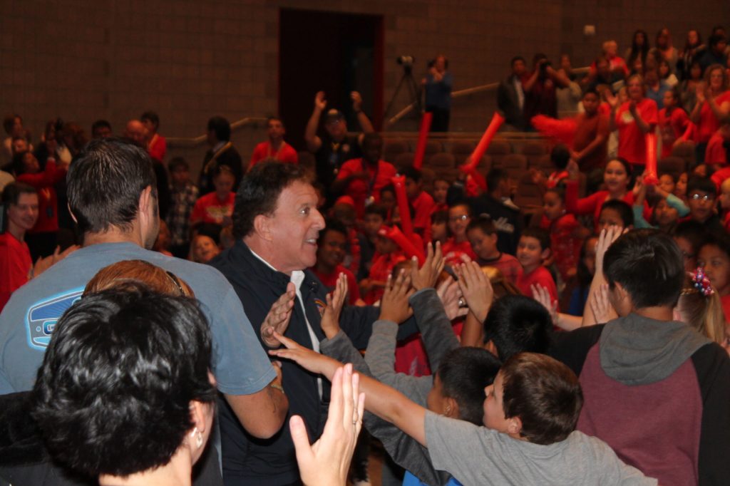 Photo by Linda Kor - Jake Steinfeld, chairman of the National Foundation for Governors’ Fitness Councils, gets a warm welcome from students at the George Gardner Performing Arts Center during a celebration of the new Don’t Quit Fitness Center at Hulet Elementary School.