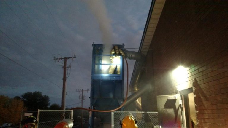 Photo courtesy of the Taylor-Snowflake Fire & Medical Department - Two arson fires were set at Snowflake High School early last week, including this one at the woodshop hopper being fought by a fireman from the Taylor-Snowflake Fire & Medical Department.