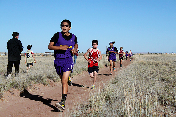 Photo courtesy of the Native American Christian Academy - NACA cross-country runner Eligle Begay (in front) gives his all while competing in the Navajo Hopi Apache Junior High League boys’ race.