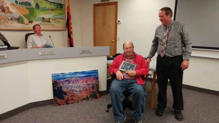 Photo by Naomi Hatch - Tom Poscharsky (left) was acknowledged last week for the many hours of service he gave the Town of Snowflake during his tenure as mayor. Poscharsky received a chair and a plaque, and a landscape of the Grand Canyon. Mayor Lynn Johnson (right) presented him with the plaque.