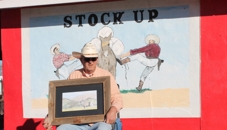Photo by Chanae Nielson - Local cowboy artist Michael McCray holds one of his original drawings that depict life in rural northern Arizona.