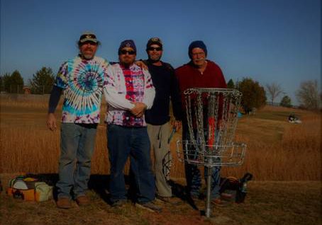 Photo courtesy of Tom Poscharsky - Snowflake disc golf course project manager Steve Johnston and friends (left to right) Guy Simpson, Benny Serna and Joel Nuttall stand behind a basket at the new Snowflake Disc Golf Course.