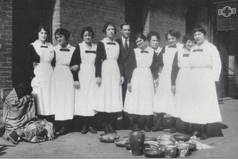 Photo courtesy of the Old Trails MuseumStanding in front of the old Winslow Harvey House in 1918, these young women wore the distinctive black and white uniforms that identified them as Harvey Girl waitresses. On the left is an Indian woman selling her pottery to hotel guests and train passengers. Third from the right is Juanita Gale Creswell, known locally as “Cecil.” She is the only known Harvey Girl to become a cattle rustler.