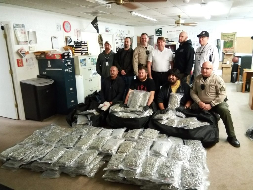 Photo courtesy of the Navajo County Sheriff’s OfficeMembers of the Navajo County Sheriff’s Office Traffic Enforcement Unit and the Major Crimes and Apprehension Team pose with a drug shipment they uncovered during a traffic stop.