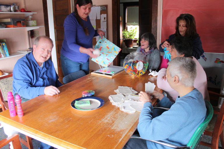 Photo by Chanae NielsonFirst Step Workshop clients in the adult day program and staff work on their Chinese New Year crafts, making a dragon and paper lanterns. Working on the project are (left to right) Kevin Shelton, staffer Colleen Neiberlein, Nancy Bushman, Program Manager Heidi Karges, Dolores Lira and Frank Vargas.