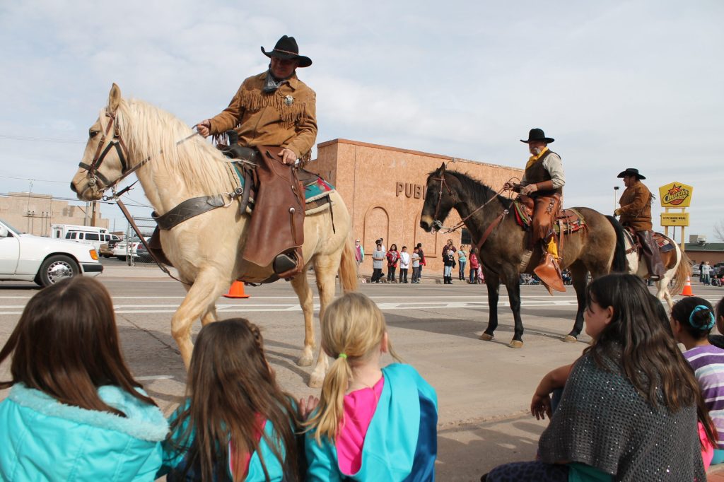Photo by Linda KorThe Hashknife Posse riders received a warm welcome in Winslow last Thursday as they visited schools and informed students about the annual Pony Express Ride that leaves at 8 o’clock this morning (Feb. 8) from the Holbrook Post Office. Riders (left to right) Tim Kelley, Walter Pacheco and Byron Shelendewa demonstrated the mail bag hand-off and visited with crowds that lined Second Street in Winslow.