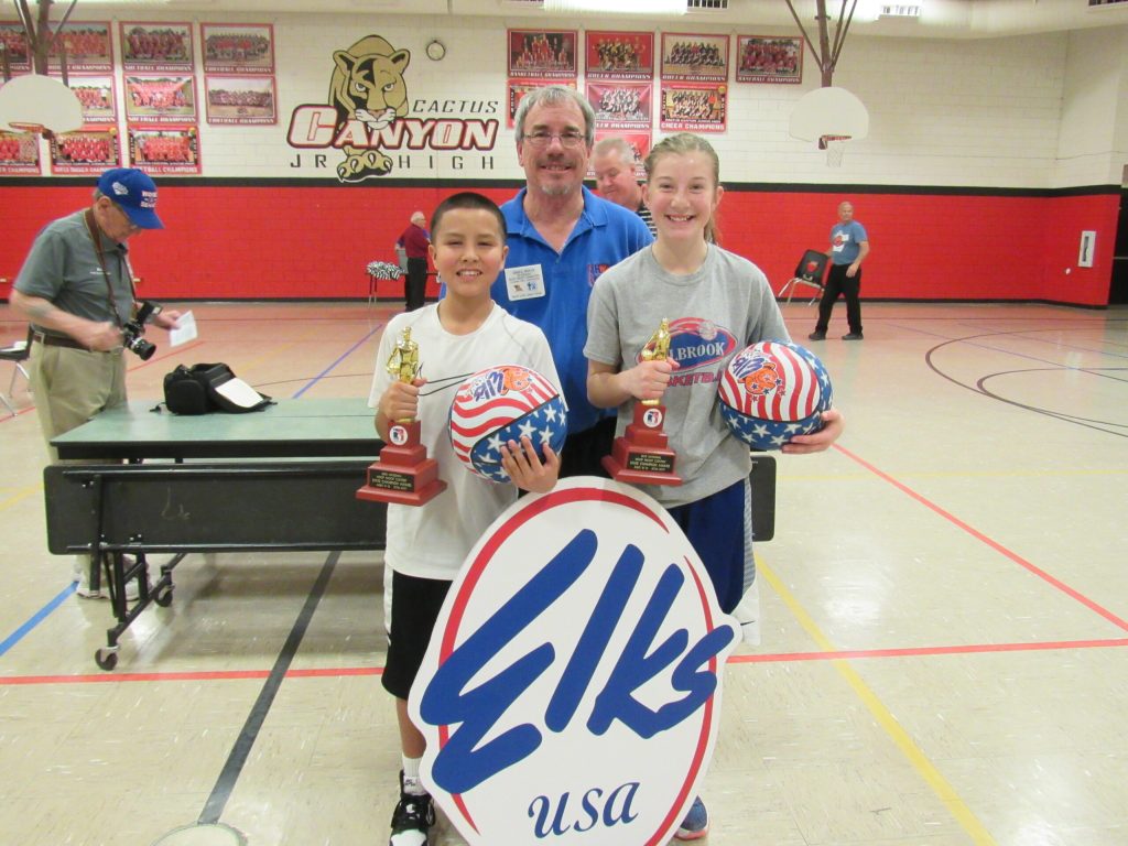 Photo courtesy of the Arizona Elks AssociationArizona Elks Association Hoop Shoot Director Gregg Boyce (center) congratulates Holbrook Junior High School students Damon Attakai (left) and Mylee Demuth (right) for winning first place in their divisions at the recent Arizona Elks Hoop Shoot contest.