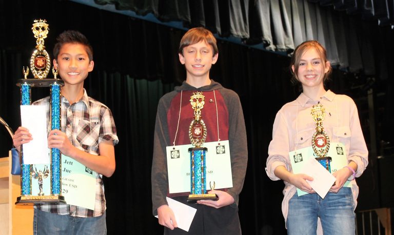 Photo by Chanae NielsonNavajo County Spelling Bee Champion Jett Jue (left), a seventh grader at Winslow Junior High School, sealed his win Feb. 15 after an intense final round by spelling the word “symbiosis” after correcting the misspelling by his competitor of the word “ephemeral.” Second place went to eighth grader Dylan Clark (middle) and third place to seventh grader Claire Lopez (right), both of Blue Ridge Junior High School.