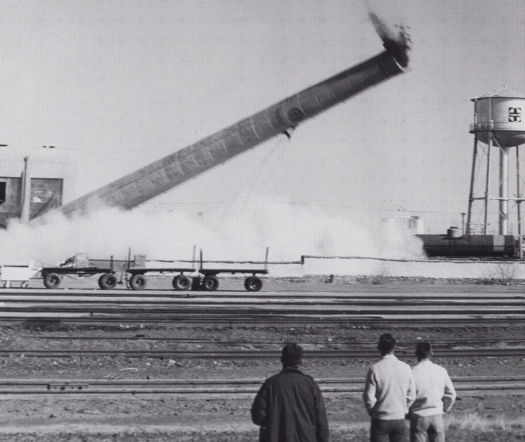 Photo courtesy of Old Trails MuseumThe railroad had built a power plant just east of La Posada to provide utilities for the hotel and the depot. When the Santa Fe division offices were moved into the then-closed hotel in 1960, a new power source was installed so the old smoke stack was knocked down on Dec. 23, 1963, in front of many spectators.