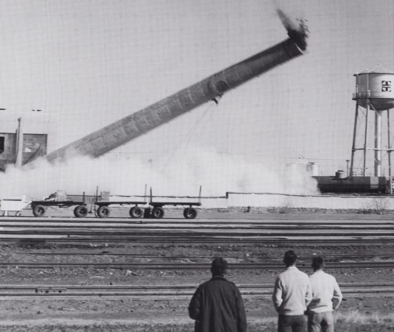 Photo courtesy of Old Trails MuseumThe railroad had built a power plant just east of La Posada to provide utilities for the hotel and the depot. When the Santa Fe division offices were moved into the then-closed hotel in 1960, a new power source was installed so the old smoke stack was knocked down on Dec. 23, 1963, in front of many spectators.