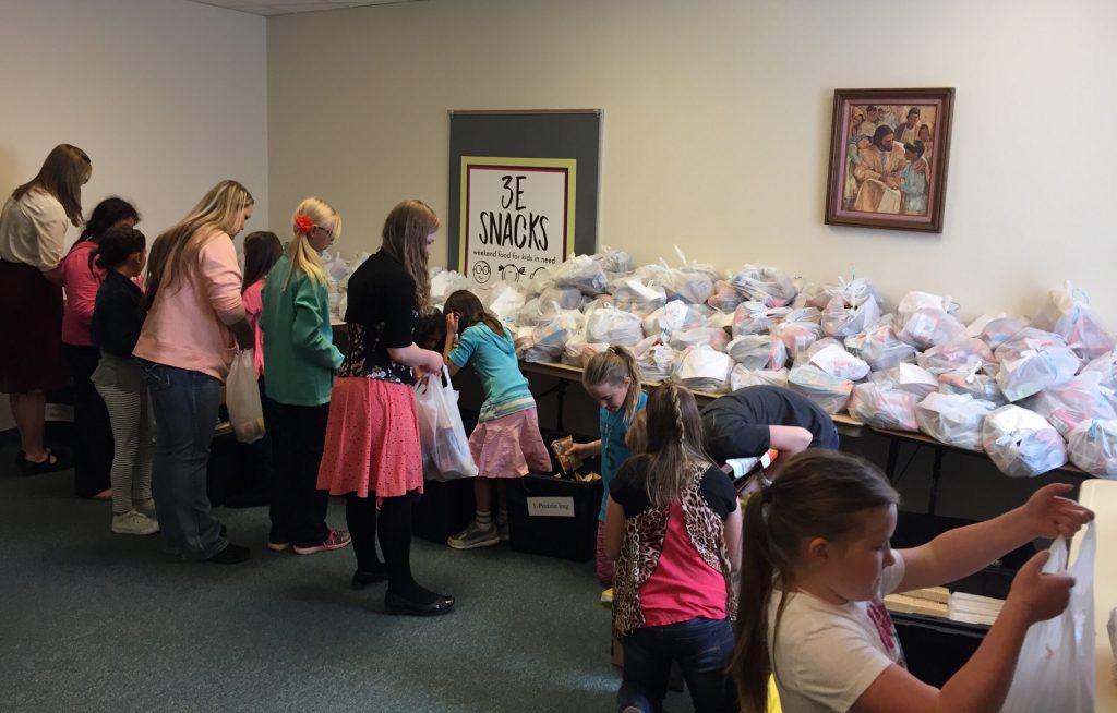 Photo courtesy of Kayley WillisA food drive hosted by 3E Snacks got the help of 81 girls ages 8 to 11 who belonged to the Centenial LDS Stake. These girls packed 270 bags to feed kids over the spring break week. Other endeavors included Cub Scout Pack 742 packing 72 bags of food and the Centenial 4th ward youth collected 655 items for the program.