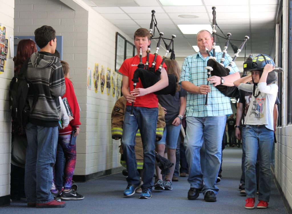 Photo by Linda KorJay Smith (right) and his son Mason Smith got a head start on the Joseph City Founders Day celebration as they played bagpipes down the halls of Joseph City High School last Friday.