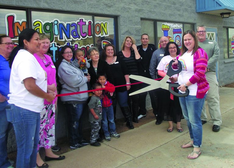 Photo by L. Parsons The Winslow Chamber of Commerce recently welcomed Imagination Station to the business community. Owner Melissa Nelson (right) wielded the scissors at the ribbon cutting. The new daycare facility offers before and after school care, all day care, preschool and an infant room. Imagination Station is located at 1313 E. Third Street in Winslow. Also present were (left to right) Tammy Curley, Michelle Pennington, Berry Larson, Lori Romero, Kathy Patton, Darcey McKee, Cathy Galvan, Michael Mendoza, Frank Guzman, Alicia Aguilar and Chamber CEO Bob Hall.