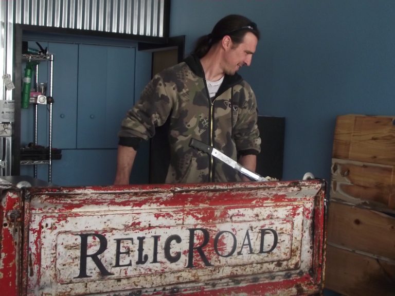 Photo by L. ParsonsThe decor inside Relic Road Brewing Company consists of “relics” the Armstrongs have found like this truck bed held by owner Troy Armstrong that will house the servers station.