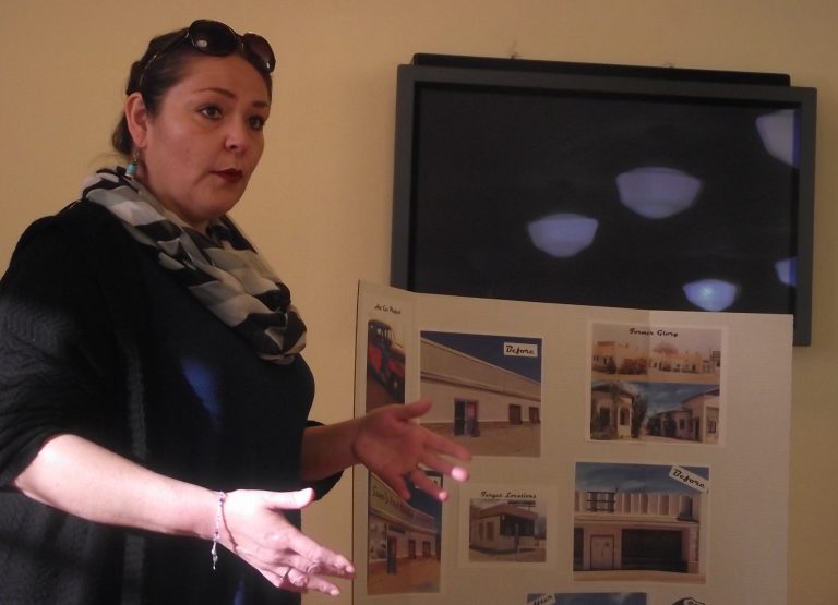 Photo by L. ParsonsRoberta Cano of the Winslow Historic Preservation Commission talks about plans to continue to improve the facades of dilapidated buildings in the area by covering them with vintage photographs printed on heavy duty, weather resistant canvas. The City of Winslow accepts applications for the beautification fund, as well as volunteer applications, at city hall, located at 21 N. Williamson Ave.