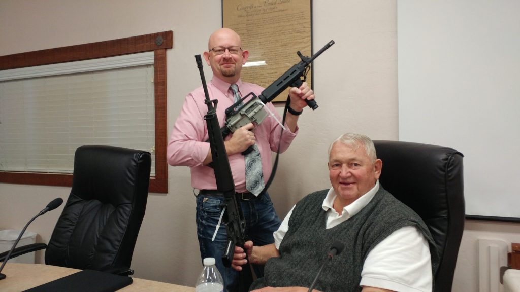 Photo by Naomi HatchCouncilors Kyle Peck (left) and Carl Cosper (right) take a close look at the M16s that the Snowflake-Taylor Police Department has been able to obtain with the help of Volunteer Don Anderson and Sgt. Dan Rush. Anderson got the Viet Nam war era rifles through military surplus at no cost and Sgt. Rush who is experienced in armor has used his skill to put the rifles in working order.