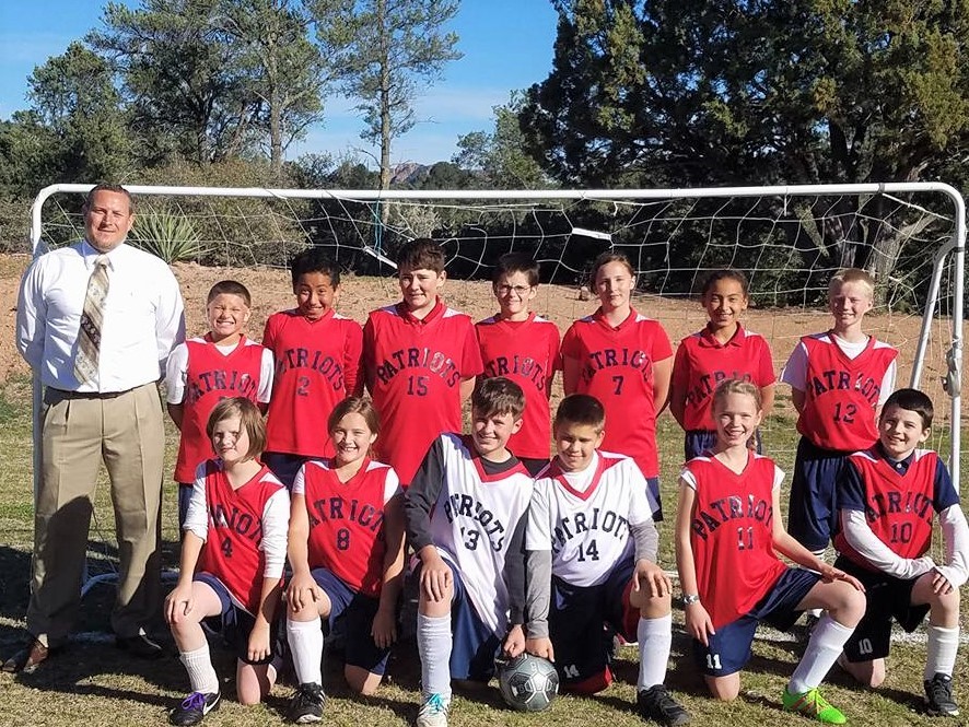 Photo courtesy of George Washington AcademyGeorge Washington Academy’s co-ed soccer team has started the season off with a bang! The Patriots are currently undefeated and have looked dangerous right from the start. GWA hosted its first home game against Northern Arizona Christian Academy April 6. Though the Patriots were outsized, they weren’t out-hustled. Dean B. scored the first goal as GWA came out on fire. NACA tied it up just before the half, but the second half started out even faster than the first as Dean netted his second goal and Karli W. followed that up with a third goal to put the Patriots up 3-1. NACA scored to tighten things up, but Jaren B. decided to celebrate his birthday with a goal of his own. It proved to be the game winner as the Patriots edged the Warriors 4-3. Logan S. and Enoch S. have taken turns in the goal and have made several big saves in each of the games. Enoch put in a tough shift in the second half of Thursday’s game as the Warriors attacked the Patriot goal with a vengeance for the last 10 minutes of the game. He and defender Kambria B. thwarted their opponents at every turn.