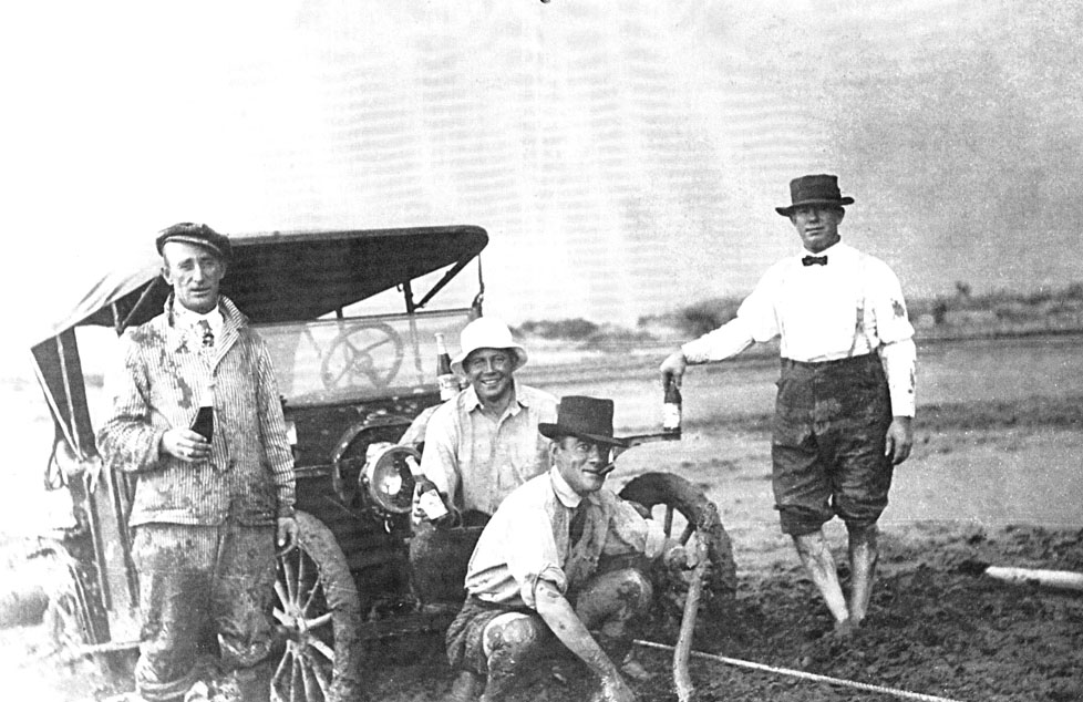 Photo courtesy of the Old Trails MuseumThe roads were still fairly primitive in the early 1900s and getting stuck was not uncommon. In this circa 1920s photograph, Winslow residents (left to right) David Figg, Gus Hanson, Joseph LeChance and Bill Kelly looked happy, but a little worse for the wear after their car was pulled from a flooded wash. They were en route to the Hopi Snake Dance planned on the Hopi Reservation north of Winslow when they were stranded for four days.