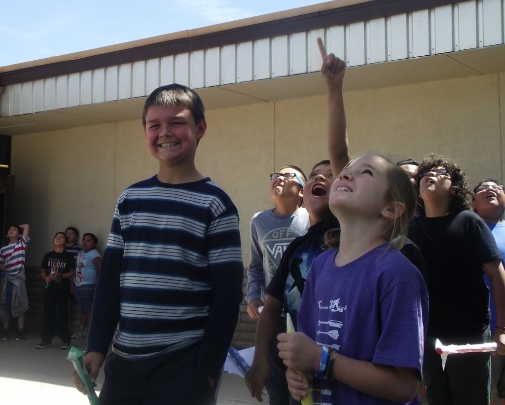Photo by L.ParsonsStudents at Bonnie Brennan Elementary School in Winslow look to the sky as their rockets blast off. Fourth grader Tyler Shumway (left), 10, explains, “The nose cone on the rockets make them more aerodynamic,” as he stands next to Adsen Leonard (right). The Arizona Science Center hosted a Science, Technology, Engineering and Mathematics Week in Winslow, visiting each elementary school. Center representatives presented hands-on learning experiments, as well as a teacher training on how to integrate STEM initiatives into their classrooms.