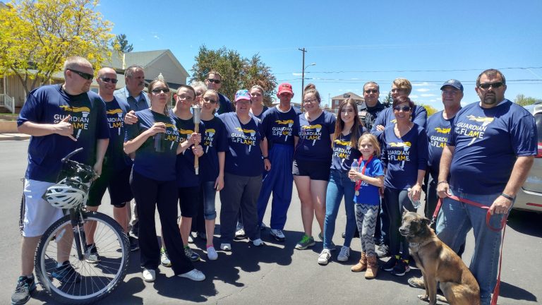 Photo by Naomi HatchThe annual Law Enforcement Torch Run for Special Olympics departed Snowflake on April 29. Participants included (front row, left to right) Det. Cristian Epps, Elizabeth Ruffell, Tony Heal, Emma Ruffell, Rilla Winder, Kristina Mukhtarova, Acy Younger, Kim Willis, K9 Smoke, Officer Jeff Whipple, (back row) Lt. Bobby Martin, Sgt. Alan DeWitt, Granny Sue Baldwin, Officer Elijah Toth, Liberty Younger, Steve Reel, Taylor Lopez, Officer Les Shumway, Dustin Burgess and Brian Carpenter. Also assisting, but not pictured, were Justin Kriter, Nancy Lubeski, Delton Woodside and Matt Krekeler of the Taylor-Snowflake Fire and Medical Department.