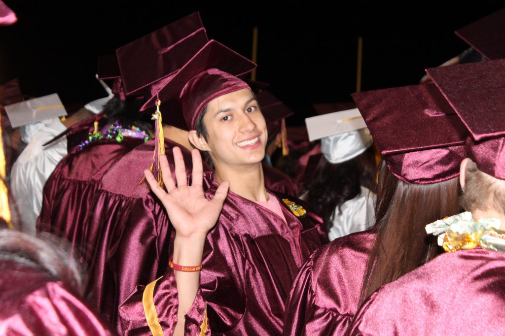 Photo by L. ParsonsWinslow High School senior Bryan Fugatt waves goodbye to his high school years as he joins his classmates for commencement exercises. For more photos from the event, please turn to Page .