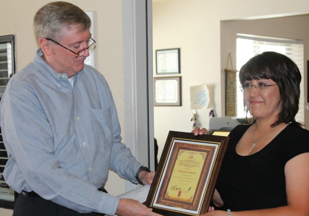 Photo by L. ParsonsU.S. Department of Agriculture Rural Development State Director Ernie Wetherbee honored Carmelita Johnson last week as Family Complex Site Manager of the Year.