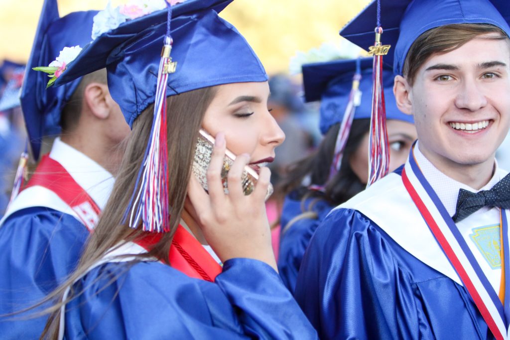 Photos by SpanglerpicsJadiana Perez (top photo, left) takes a call before Holbrook High School’s May 26 commencement exercises while friend and classmate Cooper Justman (right) waits patiently. Less than two hours later, Cade Maestas (bottom photo, left) and Shane McGraw (right) happily show off their diplomas. For more photos from the ceremony, please turn to Page .