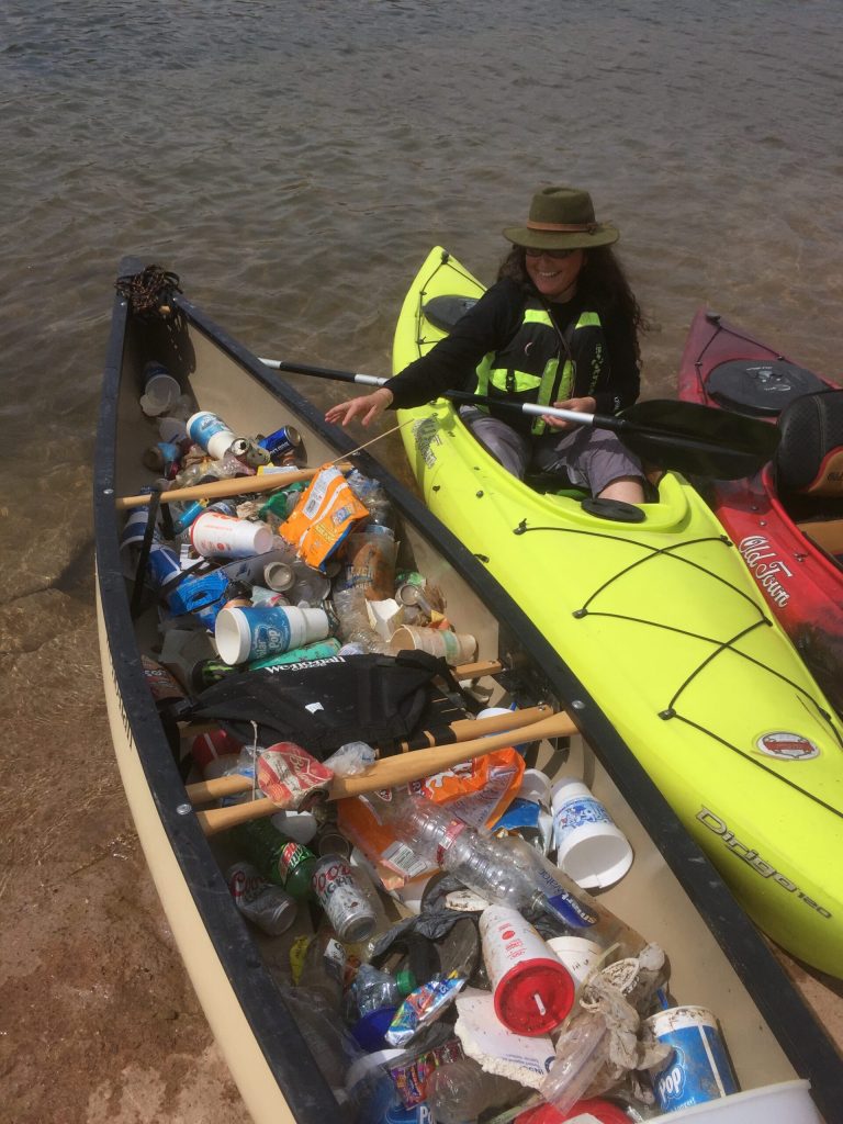 Photo by L. ParsonsSarah Herve, deputy chief of interpretation at Petrified Forest National Park, shows the garbage collected by the Native Youth Conservation Corps at Clear Creek last weekend.