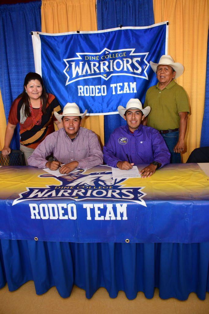 Photo courtesy of Diné CollegeDiné College Interim Provost Geraldine Garrity (left) and Interim Rodeo Coach Fred Tahe (right) were on hand as rodeo recruits Alonzo Begay (second from left) and Skylar Gishie (second from right) sign with the college.