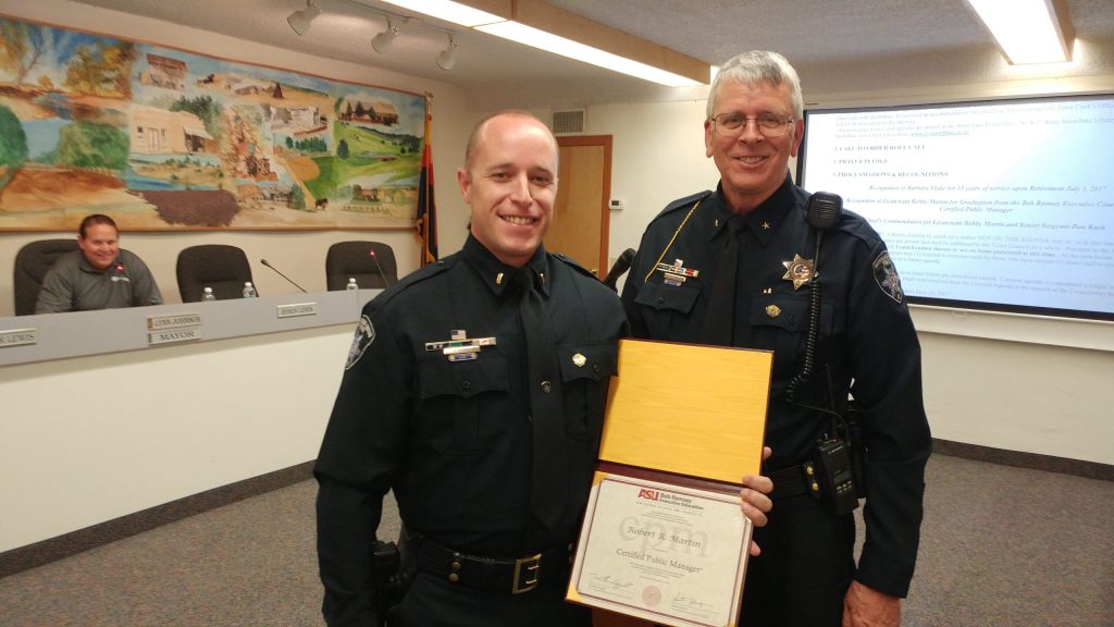 Photos by Naomi HatchSnowflake/Taylor Police Lt. Robert “Bobby” Martin (first photo, left) and Senior Sergeant Daniel Rush (second photo, left) were honored by Police Chief Larry Scarber (right in both photos) at the June 27 Snowflake Town Council meeting.