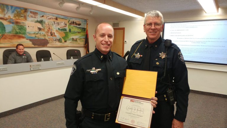 Photos by Naomi HatchSnowflake/Taylor Police Lt. Robert “Bobby” Martin (first photo, left) and Senior Sergeant Daniel Rush (second photo, left) were honored by Police Chief Larry Scarber (right in both photos) at the June 27 Snowflake Town Council meeting.