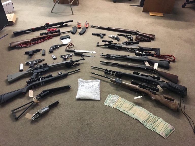 Photo courtesy of the Navajo County Sheriff’s OfficeThese weapons, drugs and cash were seized when the Major Crimes Apprehension Team served a search warrant last week at a residence in Winslow.
