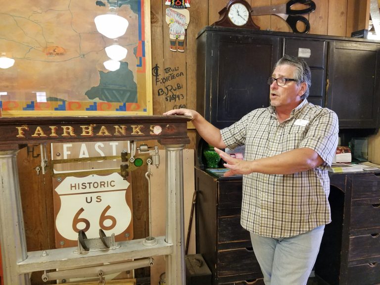 Photo by L. ParsonsWinslow Chamber of Commerce CEO Bob Hall shows off the original scale used to weigh raw wool at the Hubbell Trading Post. The scale has been there since the building was constructed in 1917.