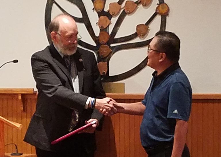 Photo by L. Parsons Thin Thai was honored with a token of appreciation from Navajo County Attorney Brad Carylon last week for his work with the Navajo County Family Advocacy Center. Carlyon said, “I’d like to recognize one of those people who, hiding in the background, does so much. It is people like Thai that make our community so great, because it gives all of us a chance to succeed.”
