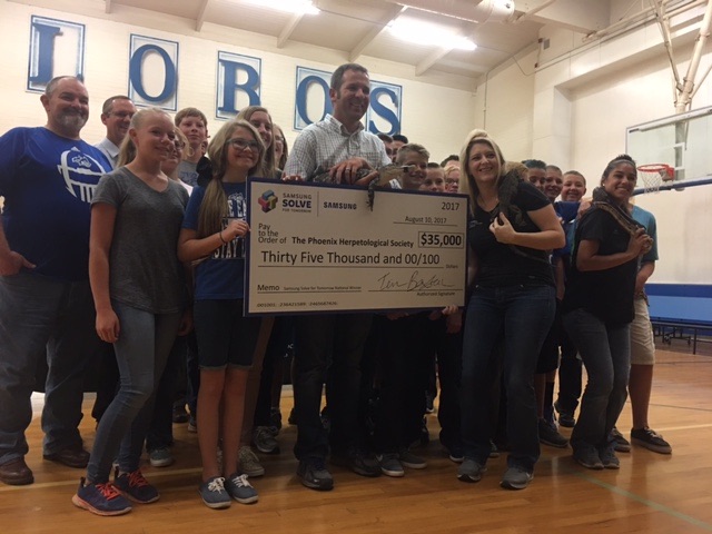 Photo courtesy of Snowflake Junior High SchoolSnowflake Junior High School students, teachers and staff presented a $35,000 check to the Phoenix Herpetological Society when representatives of the society visited the school, bringing with them some of the reptiles they work with. The check is a result of the students winning the Samsung Solve For Tomorrow science and technology contest. Along with the school’s winnings, they chose PHS as their charity of choice to receive the funds.