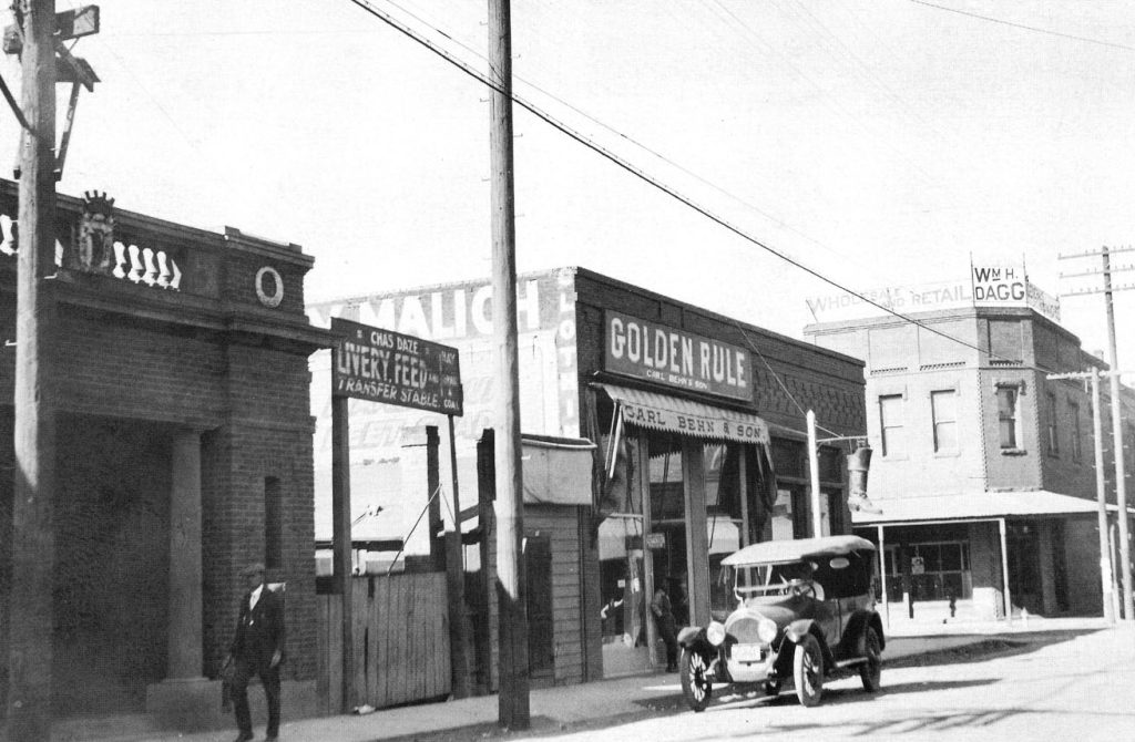Photo courtesy of the Old Trails MuseumThis photo was taken in the early 1900s at the intersection of Second Street and Kinsley Avenue in Winslow. On the right side is the Dagg Mercantile Building, one of the first brick structures in the city. It was a western wear clothing store when it burned in 1992, and the Standin’ on the Corner park now occupies the space. Across the street to the south is a 1904 bank building. Next to it, the Golden Rule was operated by the Carl Behn family and sold general merchandise. A livery stable was to the left of that and it is believed that the building on the far left was a Masonic temple, which was replaced by the Rialto Theater in 1926.